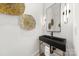 Modern powder room features a floating black sink, gold fixtures, and decorative gold wall art at 2006 St John St, Charlotte, NC 28216