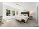 Bright bedroom features a tufted headboard, plush carpet, and large windows offering ample natural light at 2006 St John St, Charlotte, NC 28216