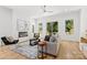 Bright living room with sleek fireplace, neutral color scheme, and large windows for natural light at 2006 St John St, Charlotte, NC 28216
