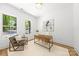 Bright home office features natural light, wood floors, and a comfortable seating area at 2006 St John St, Charlotte, NC 28216
