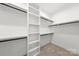 Walk-in closet features custom shelving and ample hanging space, perfect for organization at 2006 St John St, Charlotte, NC 28216