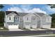 New construction townhomes with white trim, blue and gray siding, and two car garages in a contemporary style at 2027 Vinyasa Ln # Sts-40, Charlotte, NC 28215