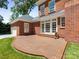 A brick patio is a backyard focal point for relaxing and entertaining in the shade at 208 Huntley Pl, Charlotte, NC 28207
