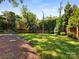 Backyard featuring a well maintained lawn and lush perimeter landscaping at 208 Huntley Pl, Charlotte, NC 28207