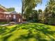 View of the yard, deck and well-manicured landscaping around the home at 208 Huntley Pl, Charlotte, NC 28207