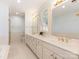 Bright bathroom with white cabinetry, dual sinks and a separate shower and toilet area at 208 Huntley Pl, Charlotte, NC 28207