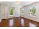 Bedroom featuring hardwood floors, three large windows, and two closets at 208 Huntley Pl, Charlotte, NC 28207