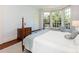 A spacious bedroom offers a sunny sitting area, wood floors and a decorative dresser at 208 Huntley Pl, Charlotte, NC 28207