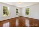 Bedroom with hardwood flooring and lots of natural light from the large windows at 208 Huntley Pl, Charlotte, NC 28207