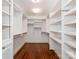Spacious walk-in closet with custom shelving and hardwood floors for organized storage at 208 Huntley Pl, Charlotte, NC 28207