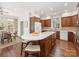 A kitchen boasts a large island, wood cabinets, white countertops, and stainless steel appliances at 208 Huntley Pl, Charlotte, NC 28207