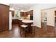 A kitchen showcases an island with seating, custom wood cabinets, and stainless steel appliances at 208 Huntley Pl, Charlotte, NC 28207