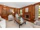 Living room with beautiful wood paneling, built in shelves and fireplace at 208 Huntley Pl, Charlotte, NC 28207