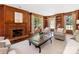 Warm living room featuring a brick fireplace, built-in shelves, and natural light at 208 Huntley Pl, Charlotte, NC 28207