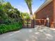 Wrought iron gate on a concrete walkway leading to the backyard at 208 Huntley Pl, Charlotte, NC 28207