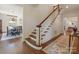 Staircase featuring wood and white trim with dining area in view at 208 Huntley Pl, Charlotte, NC 28207