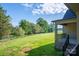 Expansive backyard featuring a lush lawn and mature trees, framed by a covered patio at 2313 Ivey Church Rd, Maiden, NC 28650