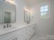 Bright bathroom featuring dual sink vanity with white cabinetry and modern fixtures and lighting at 2313 Ivey Church Rd, Maiden, NC 28650