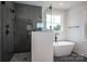 A luxurious bathroom boasts a soaking tub and walk-in shower, ideal for relaxation at 2313 Ivey Church Rd, Maiden, NC 28650
