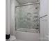 Elegant bathroom featuring stylish gray tiling in shower/tub and modern fixtures at 2313 Ivey Church Rd, Maiden, NC 28650
