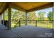 Inviting covered porch offering views of the green yard and surrounding mature trees at 2313 Ivey Church Rd, Maiden, NC 28650