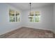 Dining room with a modern light fixture, hardwood floors, and large windows providing natural light at 2313 Ivey Church Rd, Maiden, NC 28650