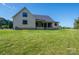 Back of the house, showcasing large yard and covered porch area at 2313 Ivey Church Rd, Maiden, NC 28650