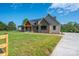 Exterior showcases stone details, a covered porch, and a well-maintained yard, creating a welcoming curb appeal at 2313 Ivey Church Rd, Maiden, NC 28650