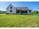 Back of the house, showcasing large yard and covered porch area at 2313 Ivey Church Rd, Maiden, NC 28650