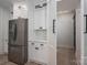 Kitchen with white cabinetry, stainless steel refrigerator, and an open doorway to another room at 2313 Ivey Church Rd, Maiden, NC 28650