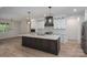Modern kitchen featuring a large island, white cabinets, and stainless steel appliances at 2313 Ivey Church Rd, Maiden, NC 28650
