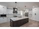 Modern kitchen featuring white cabinetry, stainless steel appliances, subway tile backsplash and a large island with dark wood base at 2313 Ivey Church Rd, Maiden, NC 28650