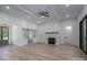 Living room featuring a stone fireplace, ceiling fan, sliding barn doors, and a large sliding glass door at 2313 Ivey Church Rd, Maiden, NC 28650