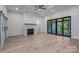 Bright living room featuring a stone fireplace, ceiling fan, sliding barn doors, and a large sliding glass door at 2313 Ivey Church Rd, Maiden, NC 28650
