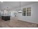 Open-concept living room and kitchen with modern lighting, large windows, and hardwood floors throughout the space at 2313 Ivey Church Rd, Maiden, NC 28650