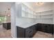 View of the pantry with white shelves and gray cabinets and drawers, quartz countertop, and stainless steel sink at 2313 Ivey Church Rd, Maiden, NC 28650
