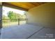 Spacious covered patio with stained wood ceiling and black railing overlooking an expansive yard at 2313 Ivey Church Rd, Maiden, NC 28650
