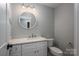 Cozy powder room featuring a modern vanity and mirror plus stylish fixtures at 2313 Ivey Church Rd, Maiden, NC 28650