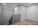 Staircase featuring modern railing and luxury vinyl flooring with an adjacent wainscoted wall at 2313 Ivey Church Rd, Maiden, NC 28650