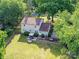 An elevated view showcasing the home, patio, and spacious fenced backyard lined with mature trees at 2315 Lawton Bluff Rd, Charlotte, NC 28226