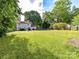 Expansive backyard featuring a well-maintained lawn, mature trees, and a patio area, perfect for outdoor entertaining at 2315 Lawton Bluff Rd, Charlotte, NC 28226