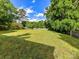 Spacious backyard with lush green grass and mature trees, enclosed by a wooden fence at 2315 Lawton Bluff Rd, Charlotte, NC 28226
