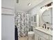 Well-lit bathroom featuring a vanity, shower with blue and white curtain, and tiled floors at 2315 Lawton Bluff Rd, Charlotte, NC 28226