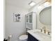 Bathroom featuring a white vanity with navy accents, round mirror, and modern light fixture at 2315 Lawton Bluff Rd, Charlotte, NC 28226