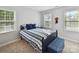 Bedroom featuring a blue bed with striped linens, carpet floors and natural light at 2315 Lawton Bluff Rd, Charlotte, NC 28226