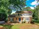 Charming two-story home with brick accents, a blue front door, and a landscaped front yard at 2315 Lawton Bluff Rd, Charlotte, NC 28226