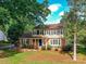Beautiful two-story home with manicured lawn, accented by brick and lush greenery at 2315 Lawton Bluff Rd, Charlotte, NC 28226