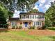 Charming two-story home with a brick and siding exterior, featuring a bright blue front door and landscaped yard at 2315 Lawton Bluff Rd, Charlotte, NC 28226