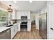 Updated kitchen with stainless appliances, white cabinets, modern backsplash and an adjacent eat-in area at 2315 Lawton Bluff Rd, Charlotte, NC 28226