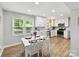 Bright eat-in kitchen features white cabinets, stainless appliances, and updated backsplash and countertops at 2315 Lawton Bluff Rd, Charlotte, NC 28226